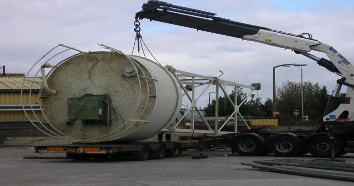 Heavy industrial equipment being lifted by a crane